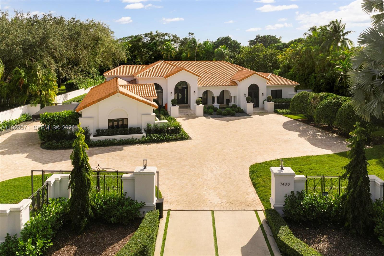 7430 Southwest 66th Street Miami, FL 33143 - Photo 37 of 43 a view of a white house with a yard plants and large tree