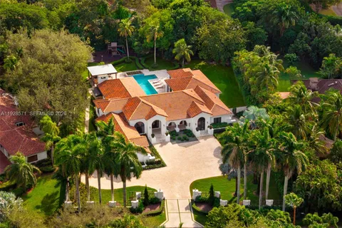 an aerial view of a house with yard and patio