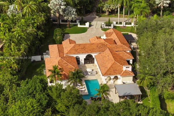 an aerial view of a house with a garden and trees