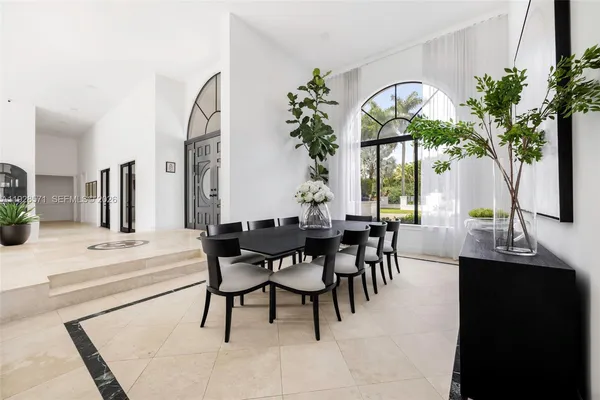 a view of a dining room with furniture and chandelier