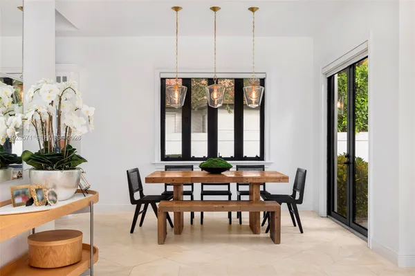 a dining room with furniture window and natural light