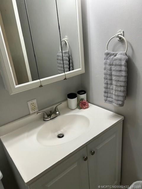 1903 Southwest Palm City Road, Unit H Stuart, FL 34994 - Photo 12 of 31 a bathroom with a sink and a mirror