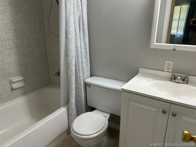 a white toilet sitting next to a bath tub