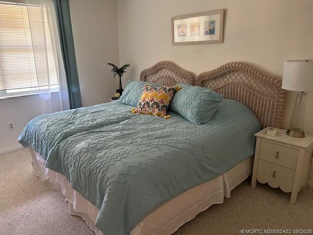 1903 Southwest Palm City Road, Unit H Stuart, FL 34994 - Photo 15 of 31 a bed sitting in a bedroom next to a window