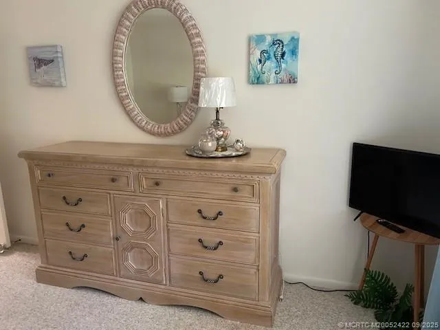 a bedroom with a bed and a mirror