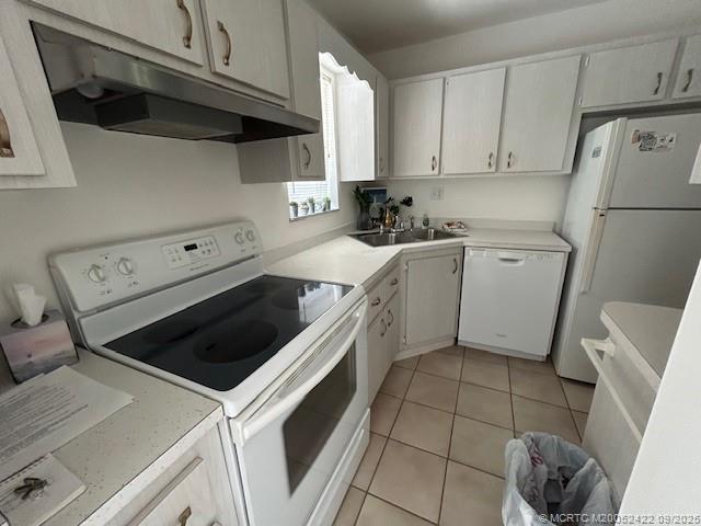 1903 Southwest Palm City Road, Unit H Stuart, FL 34994 - Photo 20 of 31 a kitchen with a white stove top oven and cabinets