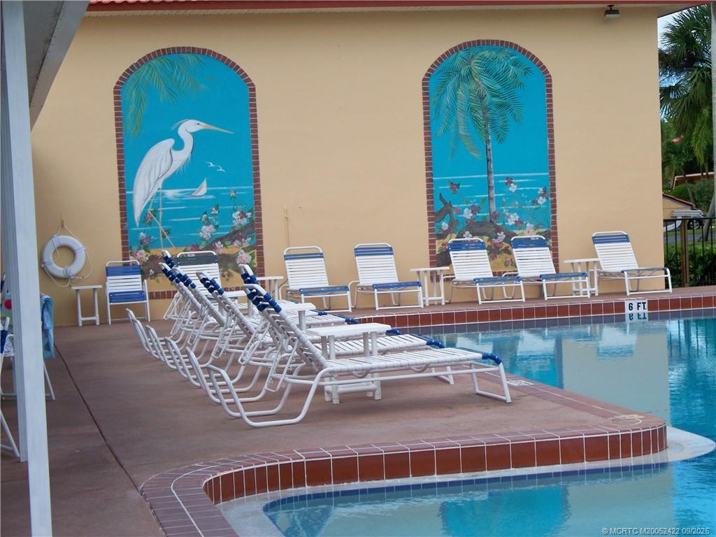1903 Southwest Palm City Road, Unit H Stuart, FL 34994 - Photo 30 of 31 a dining room with wooden floor swimming pool and outdoor view