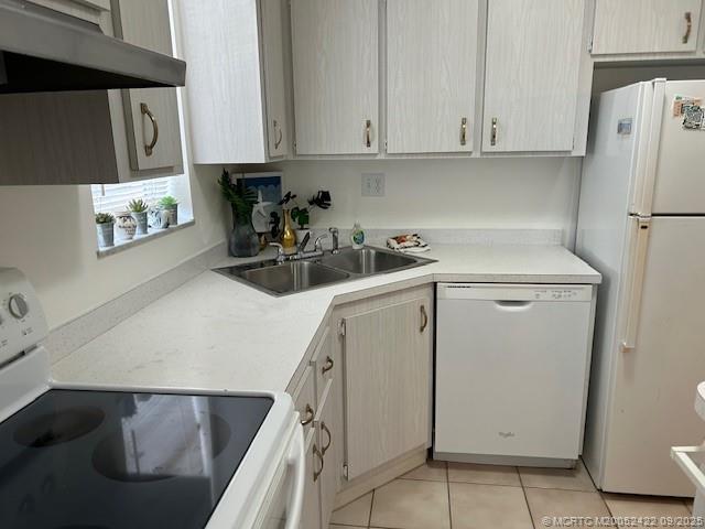 1903 Southwest Palm City Road, Unit H Stuart, FL 34994 - Photo 5 of 31 a kitchen with a refrigerator sink and cabinets