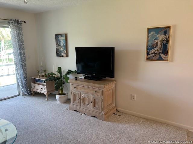 1903 Southwest Palm City Road, Unit H Stuart, FL 34994 - Photo 9 of 31 a living room with furniture and a flat screen tv