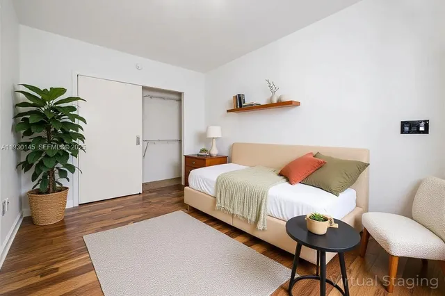 a bedroom with a bed and a potted plant