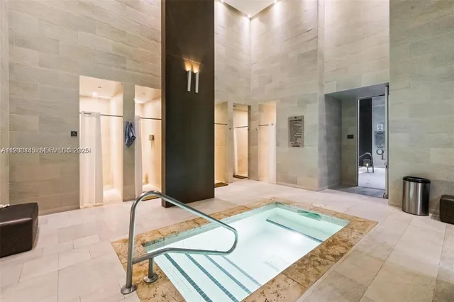 a spacious bedroom with a bed and glass door