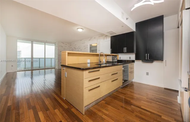a kitchen with a refrigerator and a stove top oven
