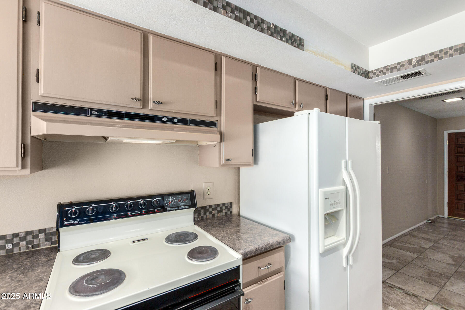 4740 West Bloomfield Road Glendale, AZ 85304 - Photo 13 of 34 a white refrigerator freezer sitting inside of a kitchen