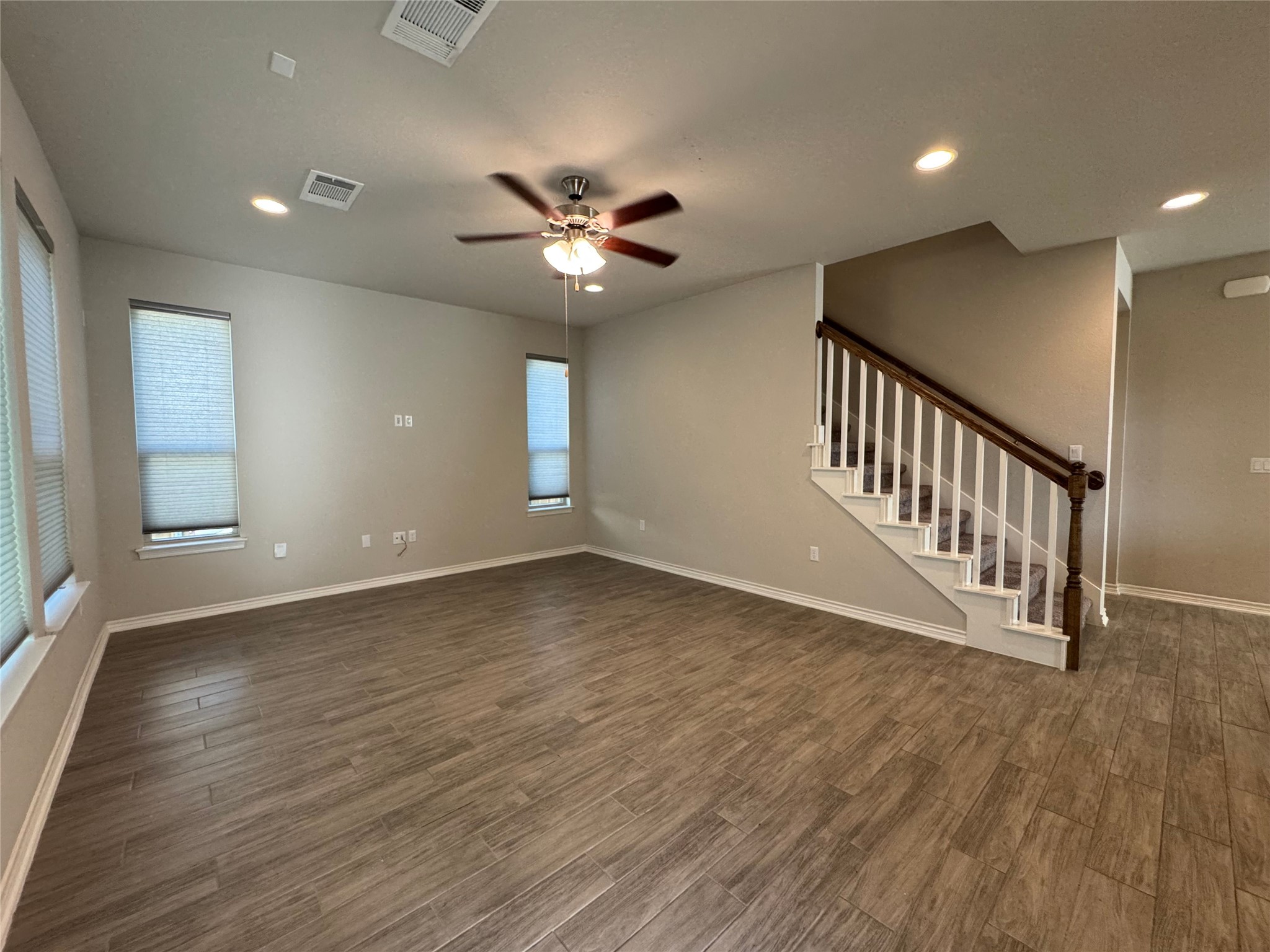14100 McCoy Loop, Unit 1 Austin, TX 78717 - Photo 11 of 39 A comfortable living area, ready for personalization, features ample space and a classic staircase.