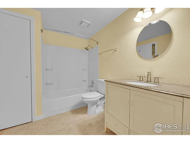 a bathroom with a toilet a sink a mirror and a bathtub