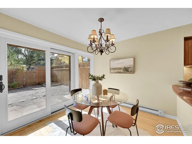 a dining room with wooden floor a glass table and chairs