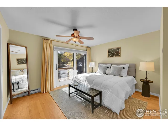 a bedroom with a bed and large window