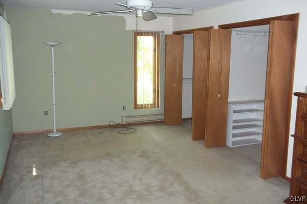 2721 Radcliff Road Bushkill, PA 18324 - Photo 4 of 19 an empty room with windows and chandelier fan