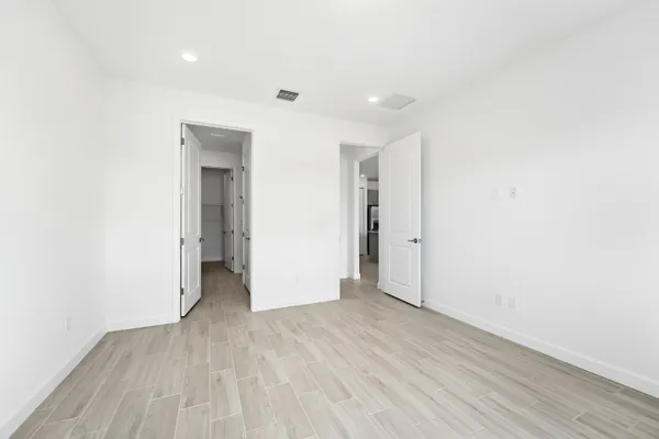a view of hallway with wooden floor