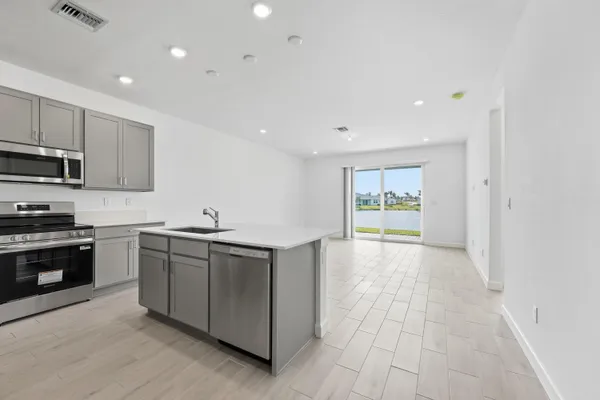 a kitchen with stainless steel appliances granite countertop a stove and a sink