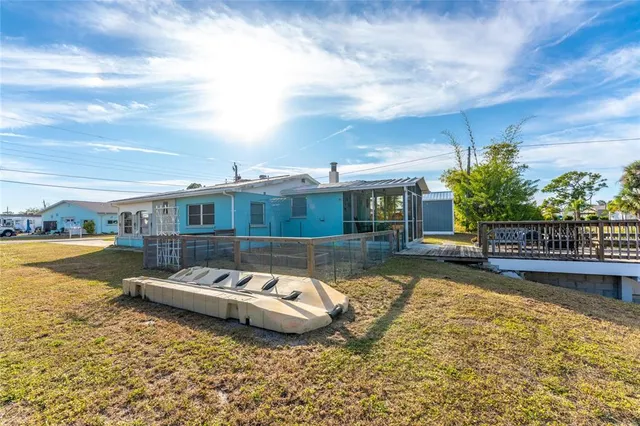 a view of a house with swimming pool and sitting area