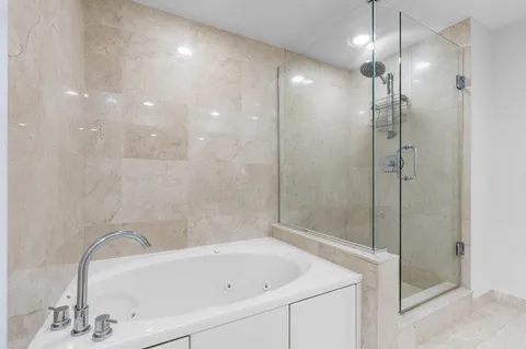 a bathroom with a bathtub and shower