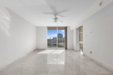 an empty room with windows and closet