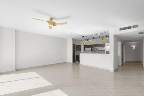 a view of a utility room with cabinet and a window