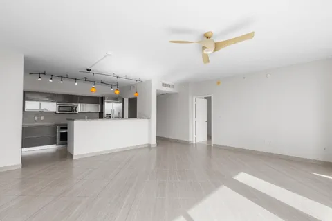 a view of a kitchen with a sink and dishwasher a refrigerator with wooden floor