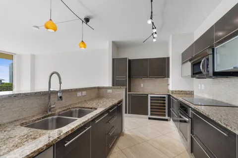 a kitchen with stainless steel appliances granite countertop a sink and stove