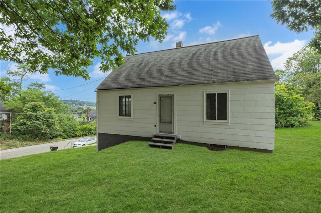a front view of a house with a garden