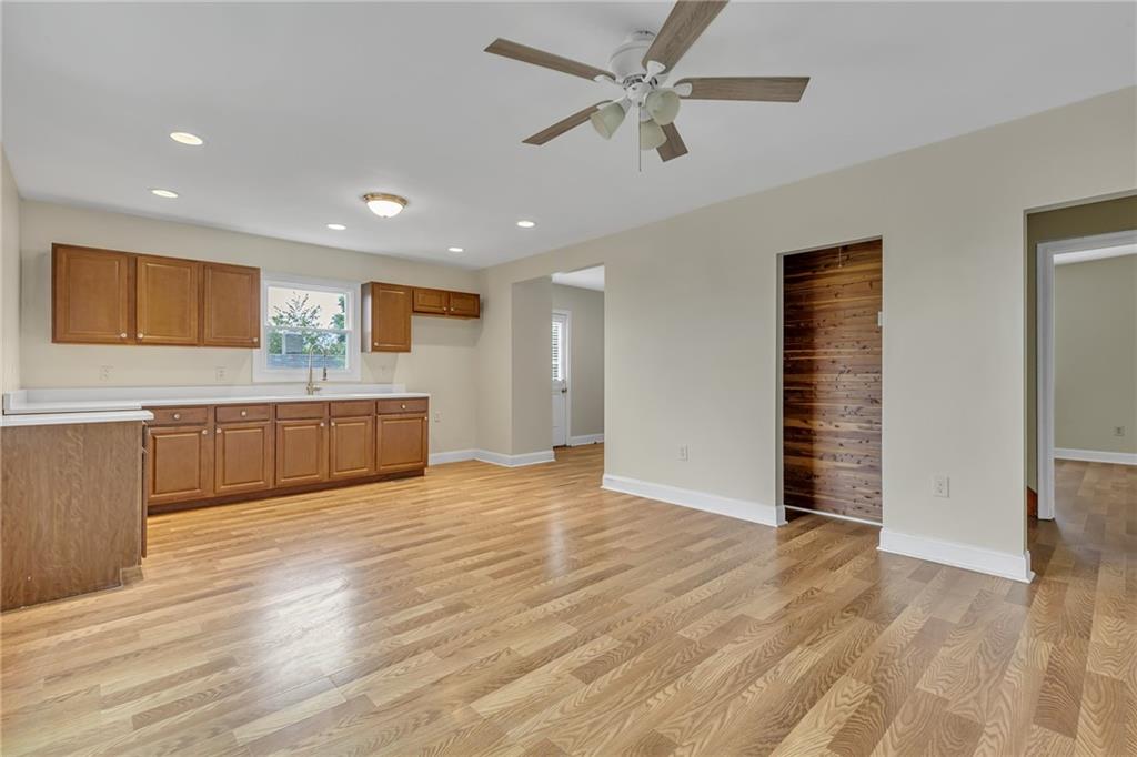 1736 Pierce Street Aliquippa, PA 15001 - Photo 5 of 19 a view of an empty room with wooden floor and a ceiling fan