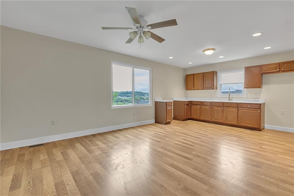 1736 Pierce Street Aliquippa, PA 15001 - Photo 7 of 19 a view of an empty room with a window and wooden floor
