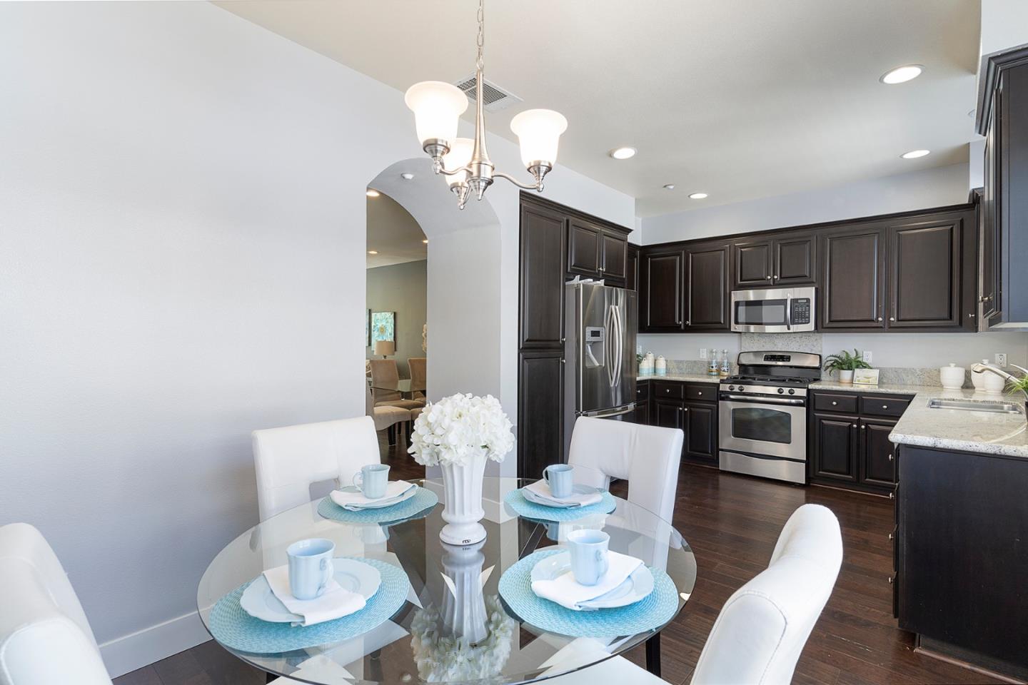 407 Topaz Terrace Sunnyvale, CA 94089 - Photo 21 of 33 a kitchen with stainless steel appliances kitchen island granite countertop a dining table and chairs