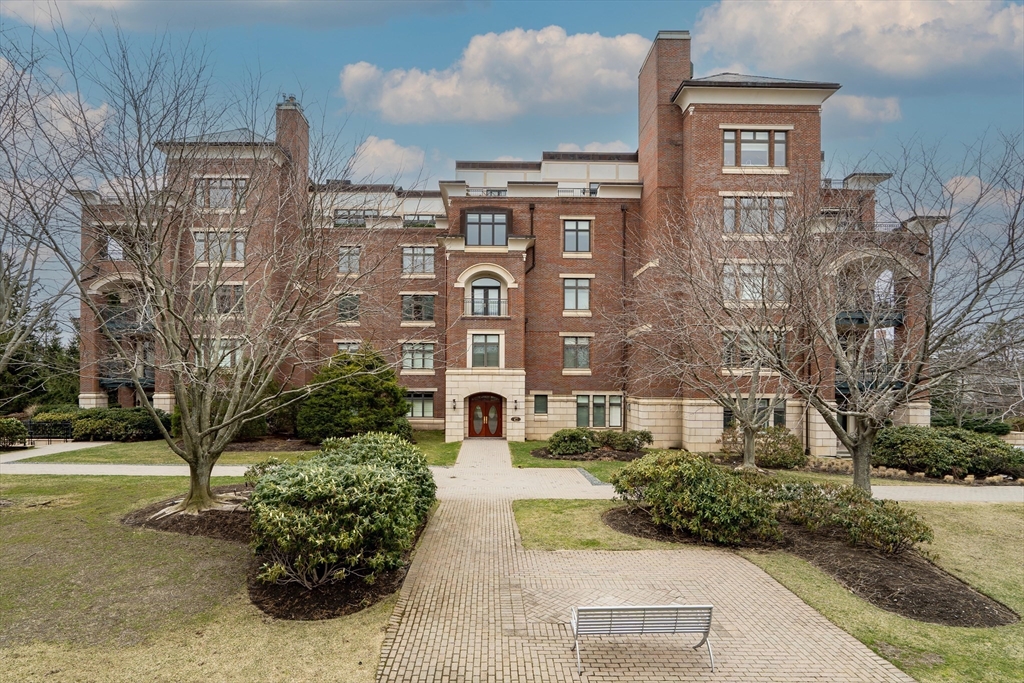120 Seaver Street, Unit C102 Brookline, MA 02445 - Photo 1 of 30 a front view of a residential apartment building with a yard