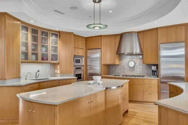 a kitchen with stainless steel appliances a sink stove and cabinets