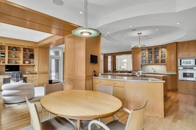 a large kitchen with a table and chairs