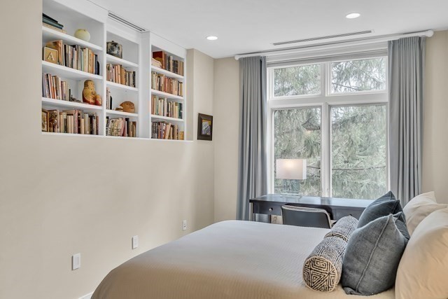 120 Seaver Street, Unit C102 Brookline, MA 02445 - Photo 17 of 30 a bedroom with a large bed and a window