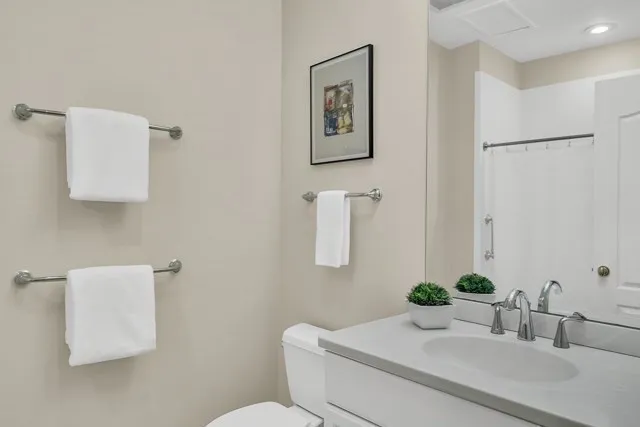 a bathroom with a sink toilet and a mirror