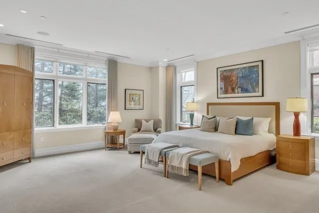 a bedroom with a large bed and a large window