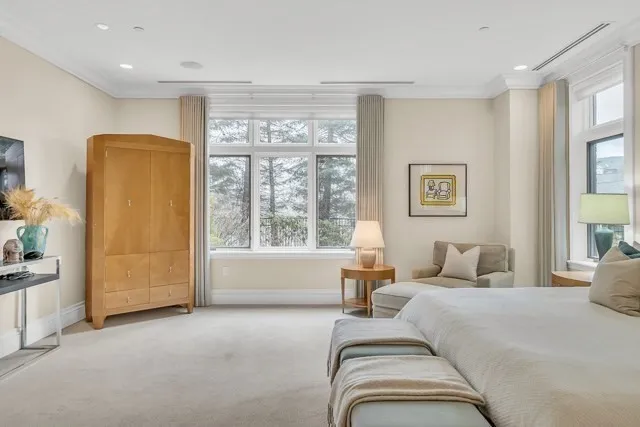 a bedroom with bed and a large window