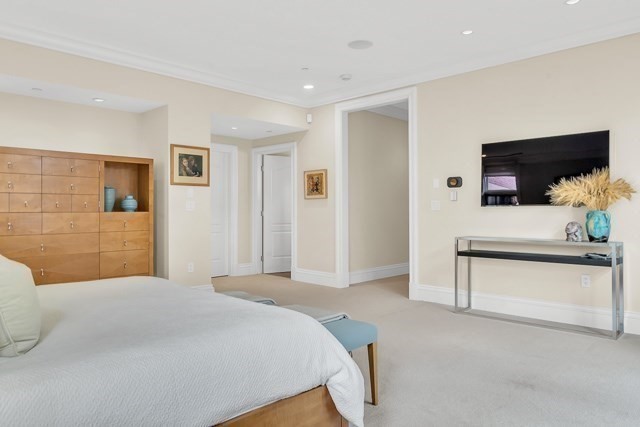 120 Seaver Street, Unit C102 Brookline, MA 02445 - Photo 23 of 30 a bedroom with a bed and a flat screen tv