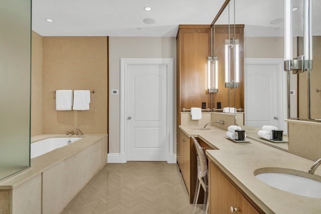 120 Seaver Street, Unit C102 Brookline, MA 02445 - Photo 24 of 30 a bathroom with a tub sink and mirror