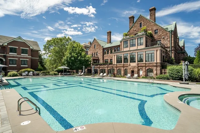 a front view of a house with swimming pool having outdoor seating