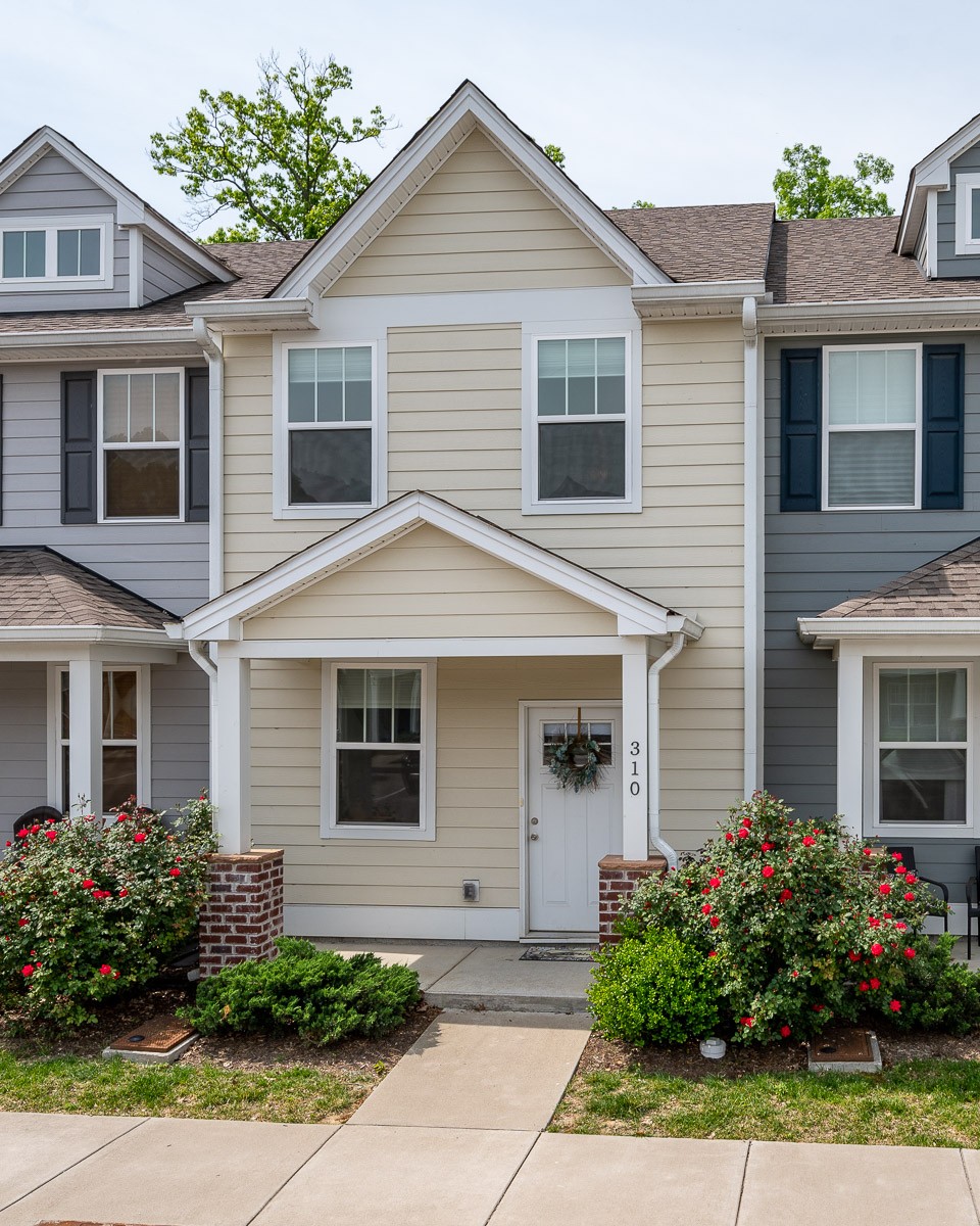 1382 Rural Hill Road, Unit 310 Antioch, TN 37013 - Photo 1 of 12 a front view of a house with a garden