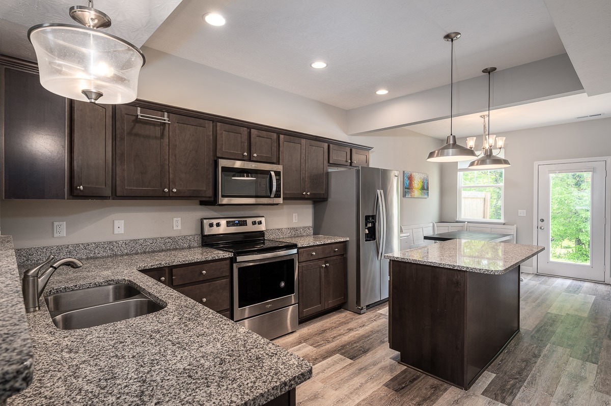 1382 Rural Hill Road, Unit 310 Antioch, TN 37013 - Photo 4 of 12 a kitchen with stainless steel appliances granite countertop a sink refrigerator and microwave