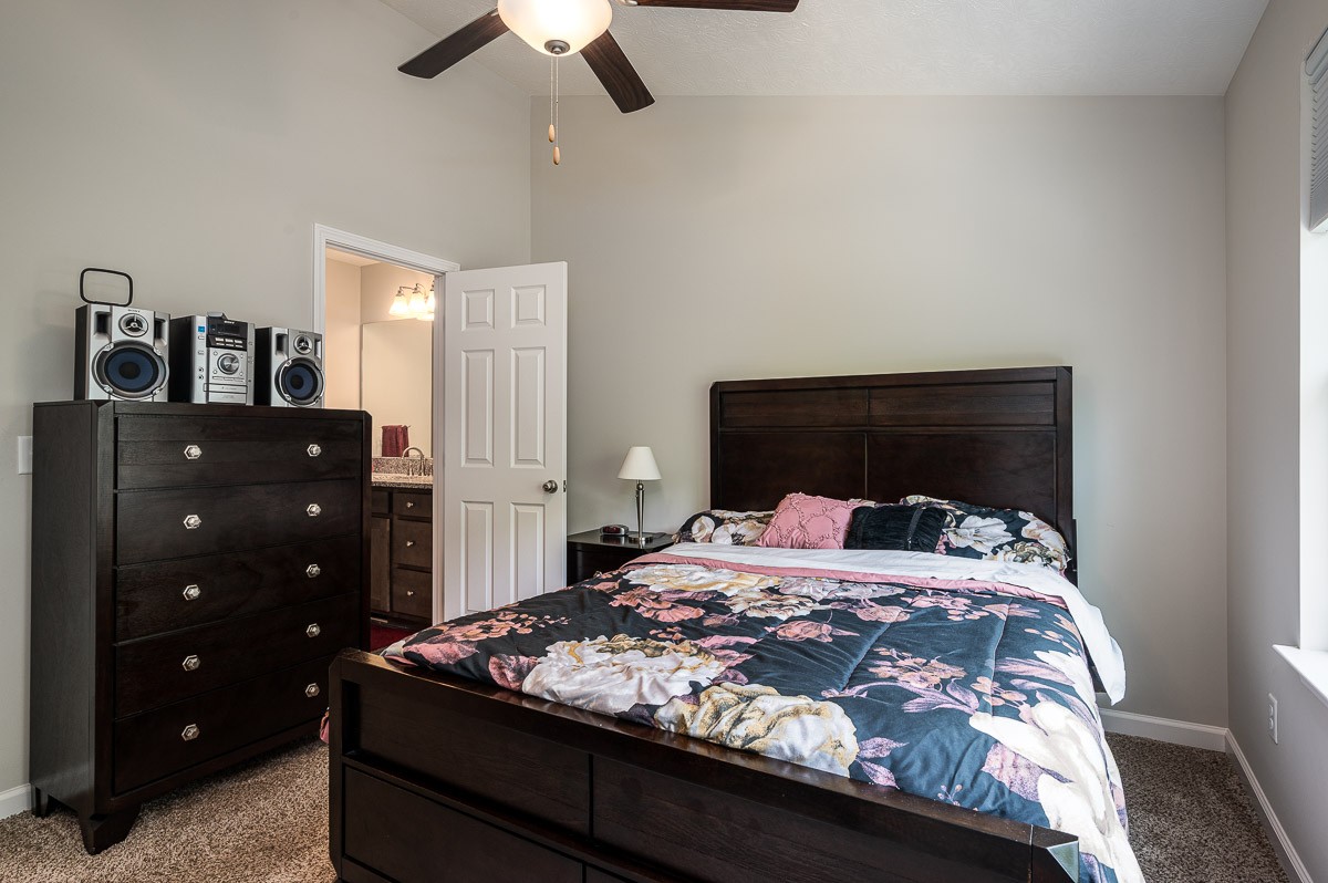 1382 Rural Hill Road, Unit 310 Antioch, TN 37013 - Photo 7 of 12 a bedroom with a bed and a dresser