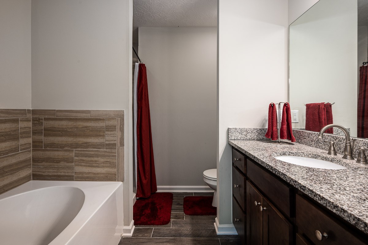 1382 Rural Hill Road, Unit 310 Antioch, TN 37013 - Photo 8 of 12 a bathroom with a granite countertop sink and a mirror