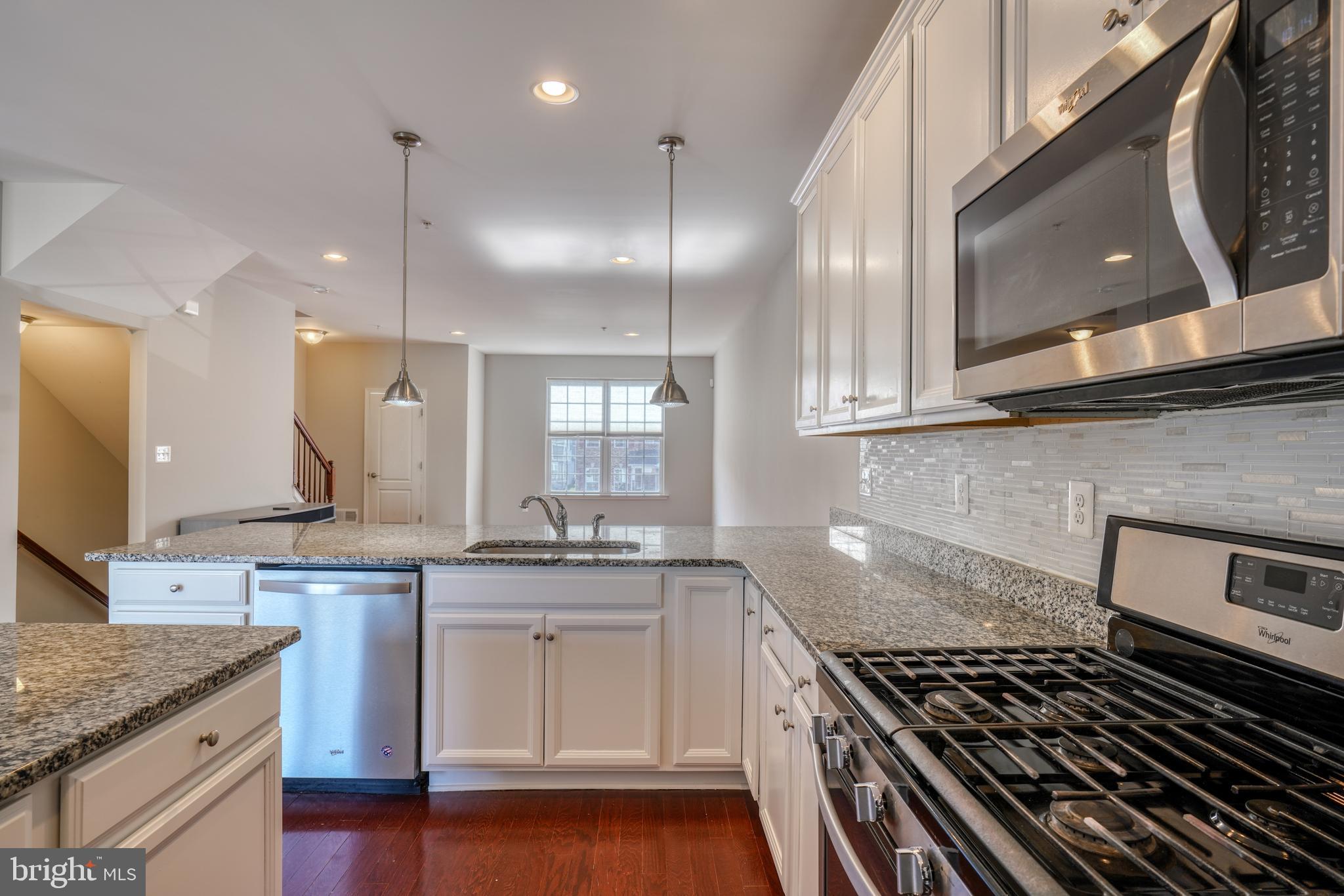 985 Morgan Run Road Middle River, MD 21220 - Photo 2 of 33 a kitchen with kitchen island granite countertop a sink a stove and cabinets