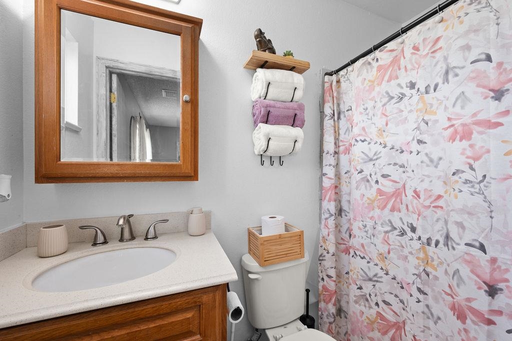 3022 Country Road Grand Junction, CO 81504 - Photo 13 of 23 a bathroom with a granite countertop sink and a mirror